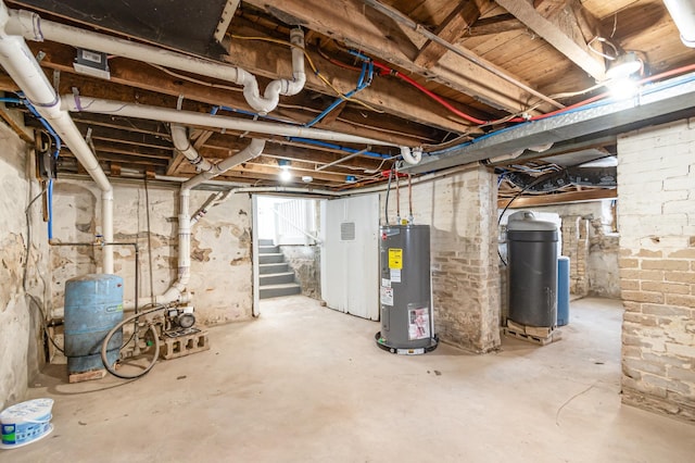 basement with water heater and stairway