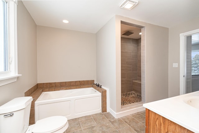 bathroom with a garden tub, toilet, vanity, tiled shower, and tile patterned floors