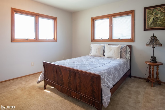 carpeted bedroom featuring baseboards