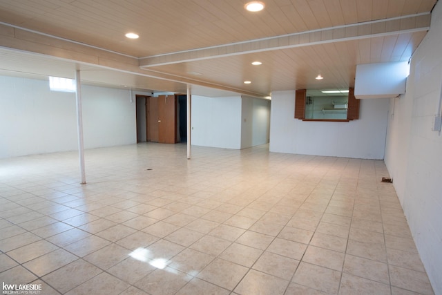 basement with wooden ceiling, light tile patterned floors, and recessed lighting