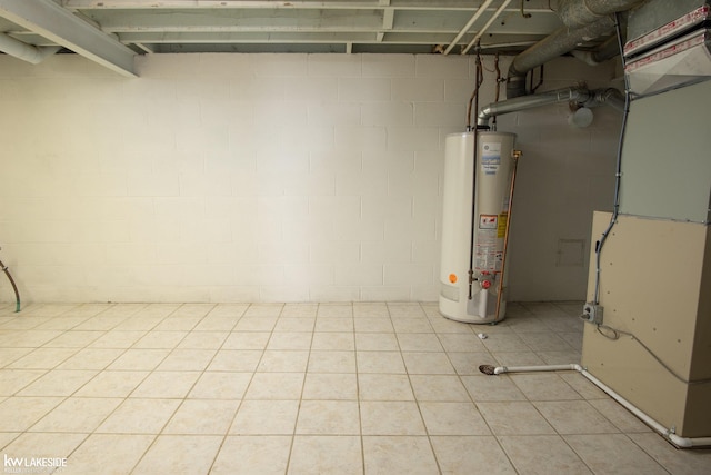 unfinished basement with gas water heater, heating unit, and light tile patterned floors