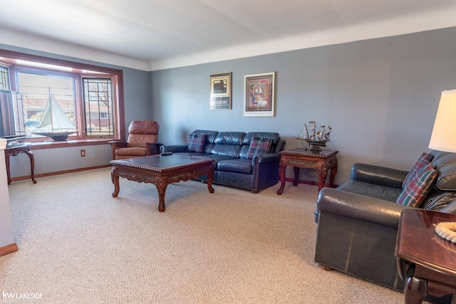 living room featuring light colored carpet and baseboards