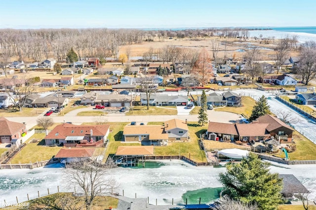 drone / aerial view with a residential view and a water view