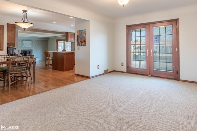 dining space with a fireplace, recessed lighting, light colored carpet, visible vents, and baseboards