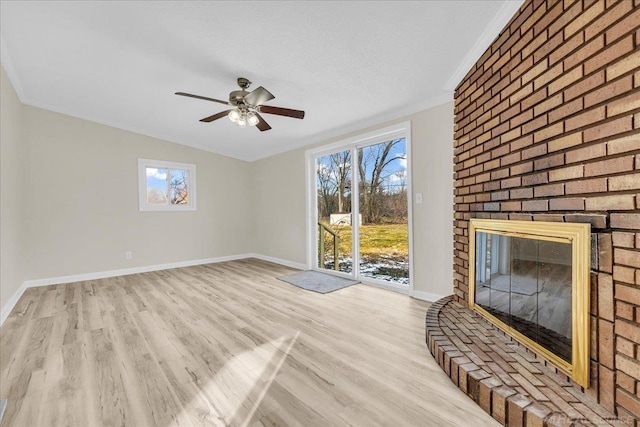 unfurnished living room featuring a healthy amount of sunlight, baseboards, and wood finished floors