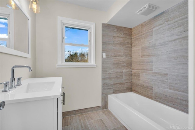 bathroom featuring plenty of natural light, vanity, and visible vents