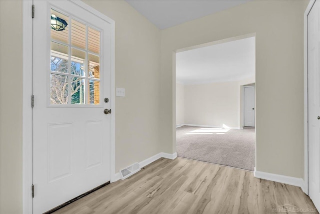 entrance foyer featuring light wood finished floors, visible vents, and baseboards