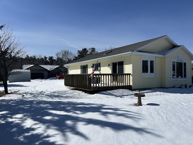 view of front facade featuring a deck and a garage