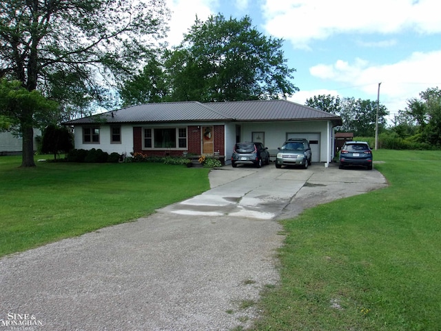 ranch-style home with metal roof, aphalt driveway, a front lawn, and an attached garage