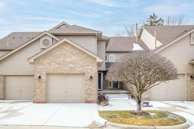 25540 Waterview Dr, Harrison Twp, MI 48045 - view of front of home with a shingled roof, an attached garage, concrete driveway, and brick siding