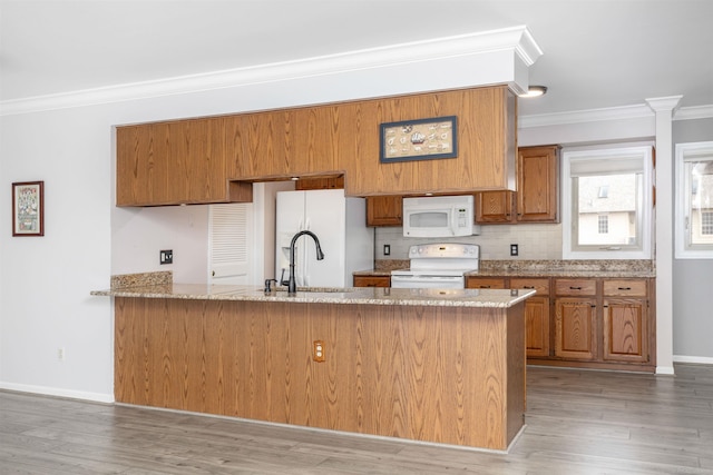 25540 Waterview Dr, Harrison Twp, MI 48045 - kitchen featuring brown cabinetry, crown molding, a sink, a peninsula, and white appliances