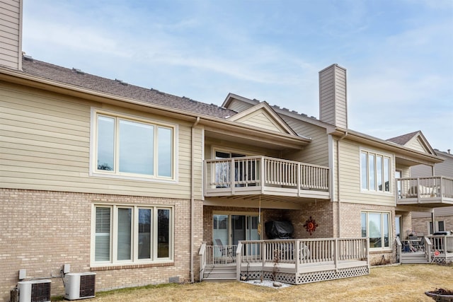 25540 Waterview Dr, Harrison Twp, MI 48045 - rear view of house featuring central air condition unit, brick siding, a chimney, and a balcony