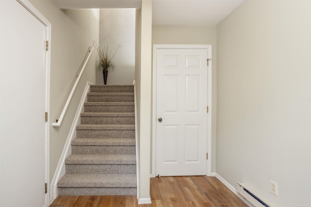 25540 Waterview Dr, Harrison Twp, MI 48045 - stairway with baseboards, a baseboard radiator, and wood finished floors