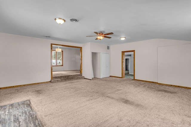 spare room featuring carpet flooring, ceiling fan, visible vents, and baseboards