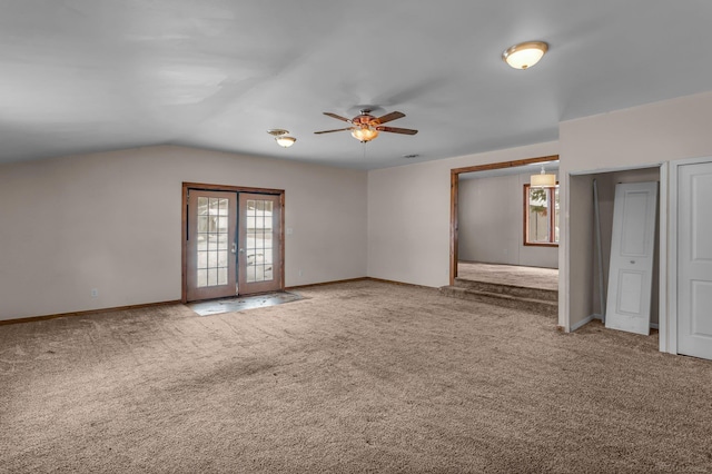 carpeted empty room with vaulted ceiling, ceiling fan, french doors, and baseboards