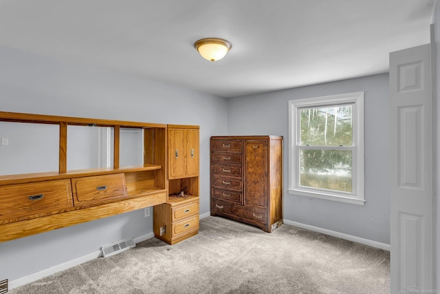 home office with visible vents, light carpet, and baseboards