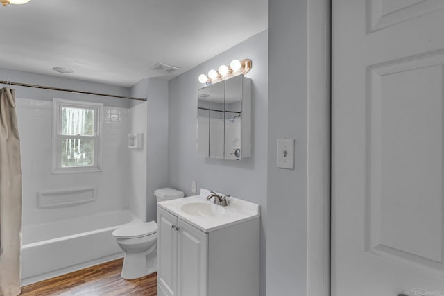 full bath with visible vents, toilet, shower / bath combo, vanity, and wood finished floors