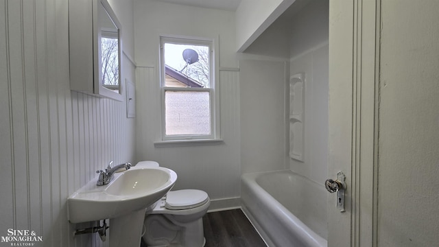 full bath featuring toilet, baseboards, and wood finished floors