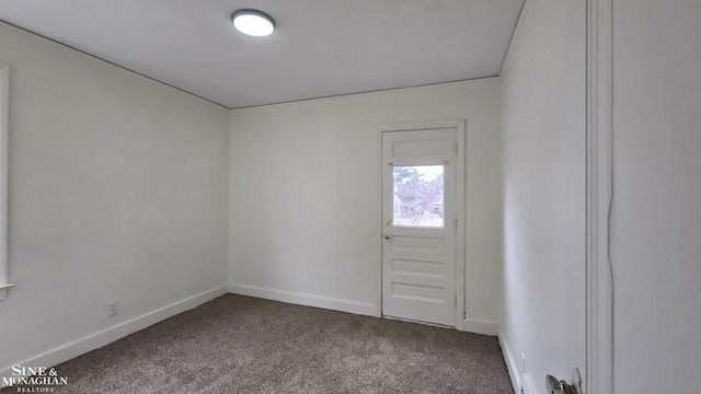 spare room with carpet flooring and baseboards