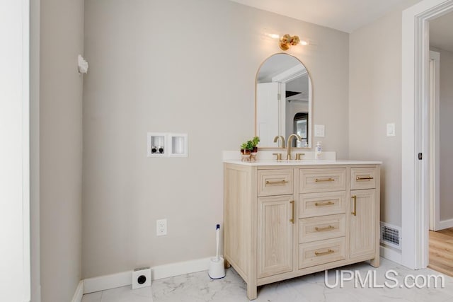 bathroom featuring marble finish floor, visible vents, vanity, and baseboards