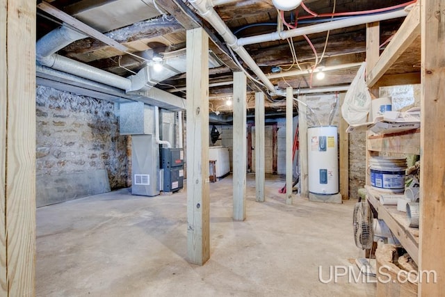 unfinished below grade area featuring electric water heater and heating unit