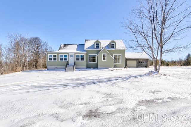 cape cod-style house with a garage