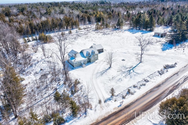 snowy aerial view with a forest view