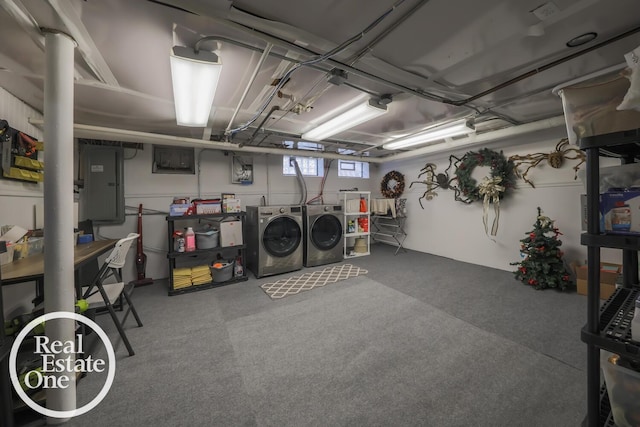 below grade area featuring electric panel and washer and dryer