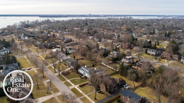 birds eye view of property with a residential view and a water view