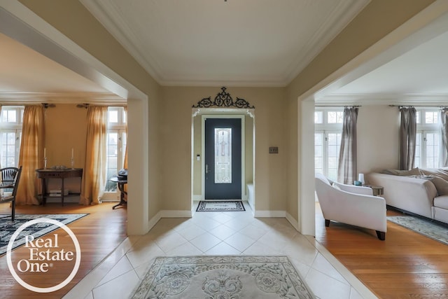 foyer entrance with plenty of natural light and crown molding