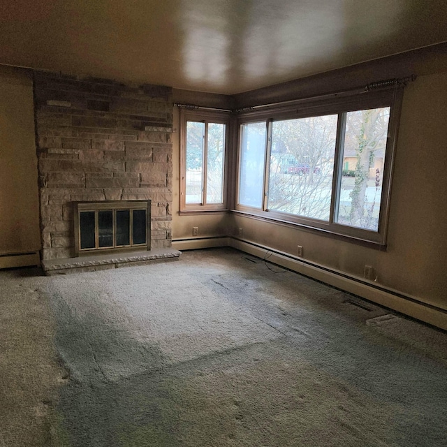 unfurnished living room with carpet, a fireplace, and baseboards