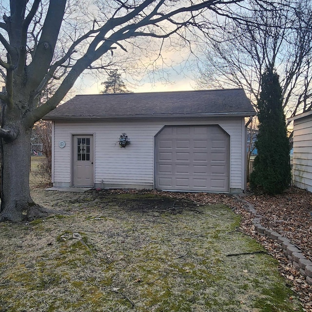 view of garage at dusk