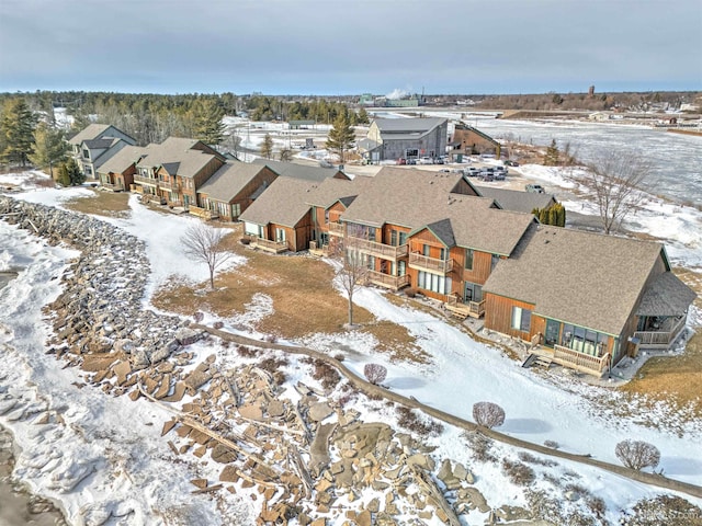 snowy aerial view with a residential view