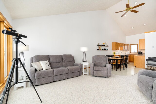 living room featuring ceiling fan and high vaulted ceiling