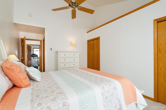 bedroom with ceiling fan, high vaulted ceiling, and baseboards