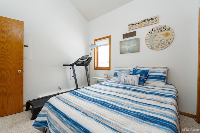 bedroom featuring lofted ceiling, baseboards, and carpet flooring