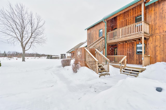 snow covered house with stairway