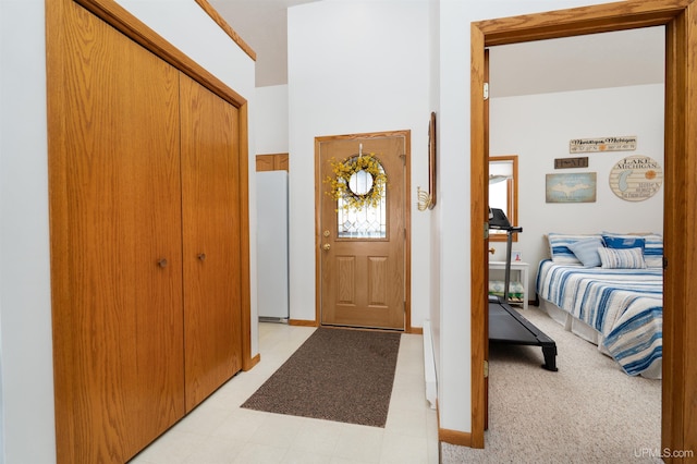 entryway featuring baseboards and light floors