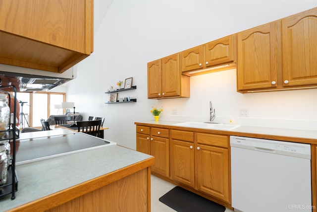 kitchen with white dishwasher, light countertops, and a sink