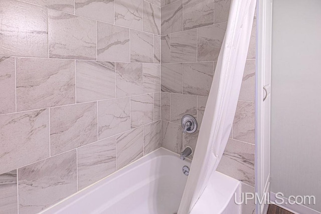 full bath featuring shower / tub combo with curtain