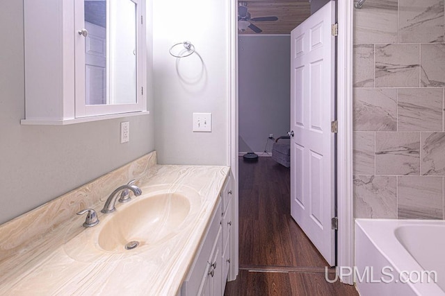 full bath with wood finished floors, vanity, and a ceiling fan