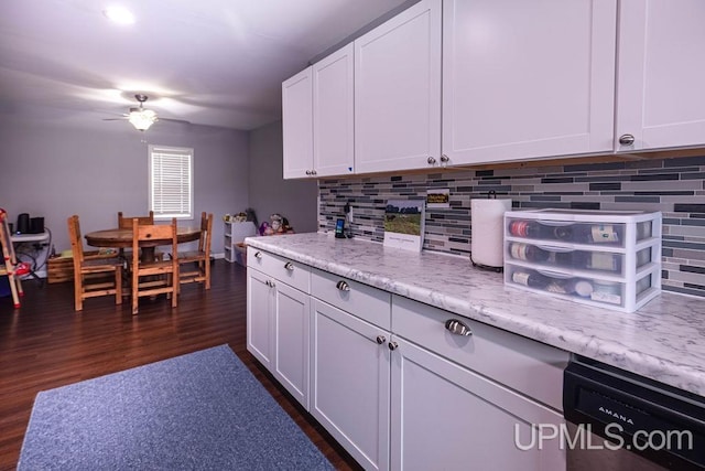 kitchen with white cabinets, dishwashing machine, decorative backsplash, and dark wood-style flooring