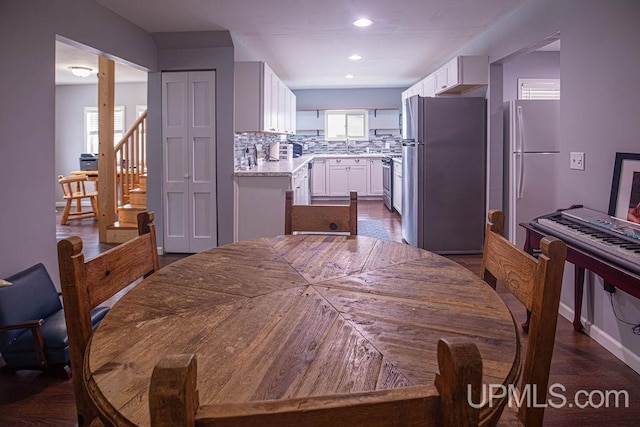 dining space featuring a wealth of natural light, stairway, and recessed lighting