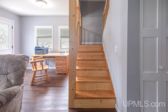 stairway with baseboards and wood finished floors