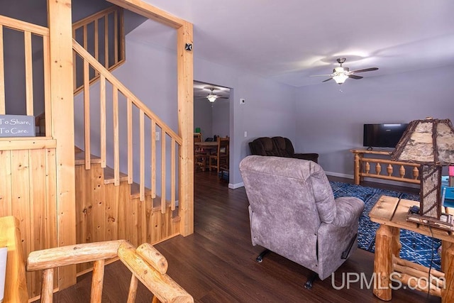 living room with ceiling fan, stairway, baseboards, and wood finished floors