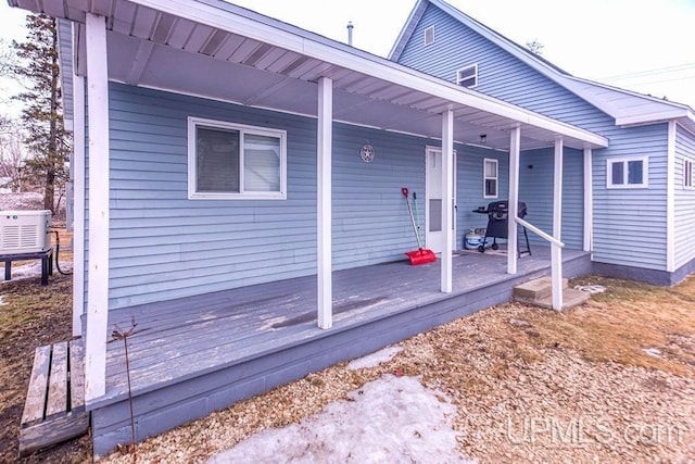 exterior space featuring a porch and a grill