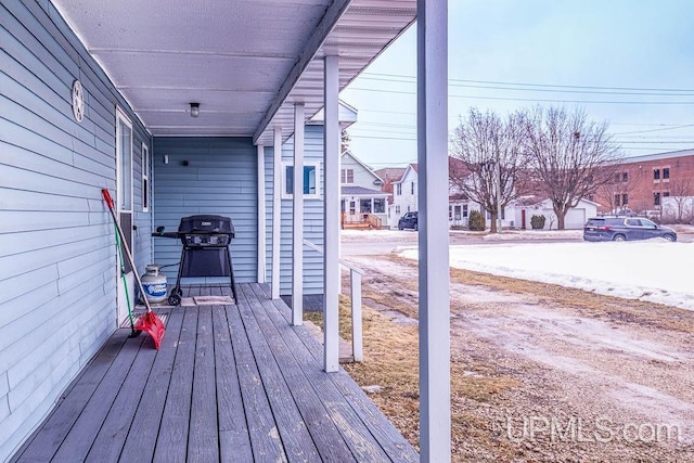 deck with a residential view and a grill