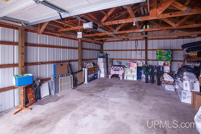 garage featuring metal wall and a garage door opener