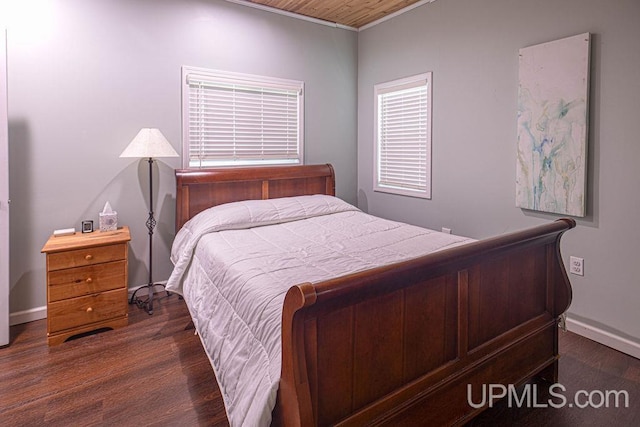 bedroom featuring dark wood-type flooring and baseboards