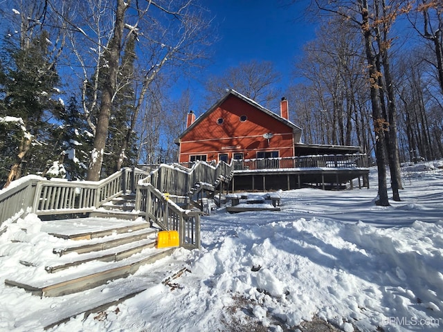 exterior space with a chimney and a wooden deck